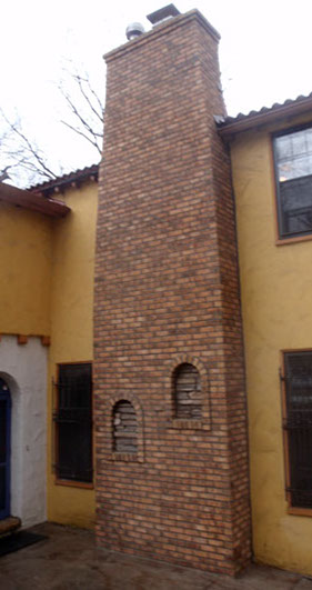 Chimney after we completely removed the original. We used a more duable brick and followed a similar design and style to fit the building.