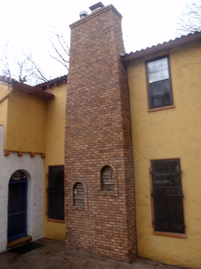 Chimney after we completely removed the original. We used a more duable brick and followed a similar design and style to fit the building.